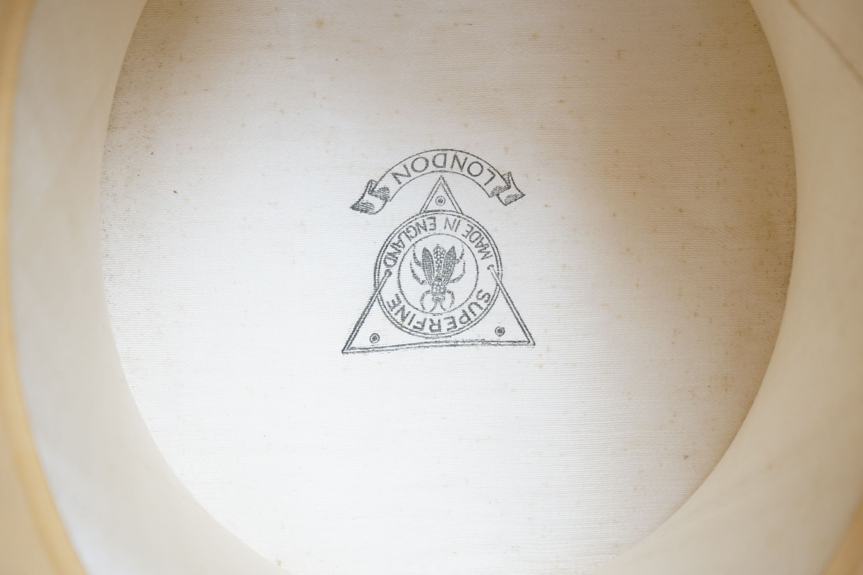 A top hat (boxed) and a cream vanity case